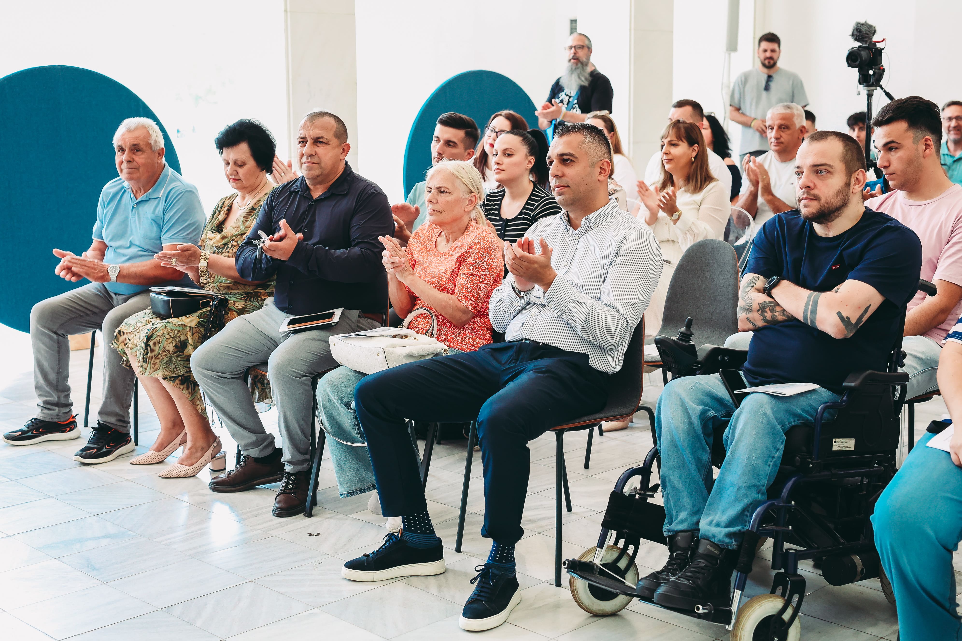 Participants applauding during the conference